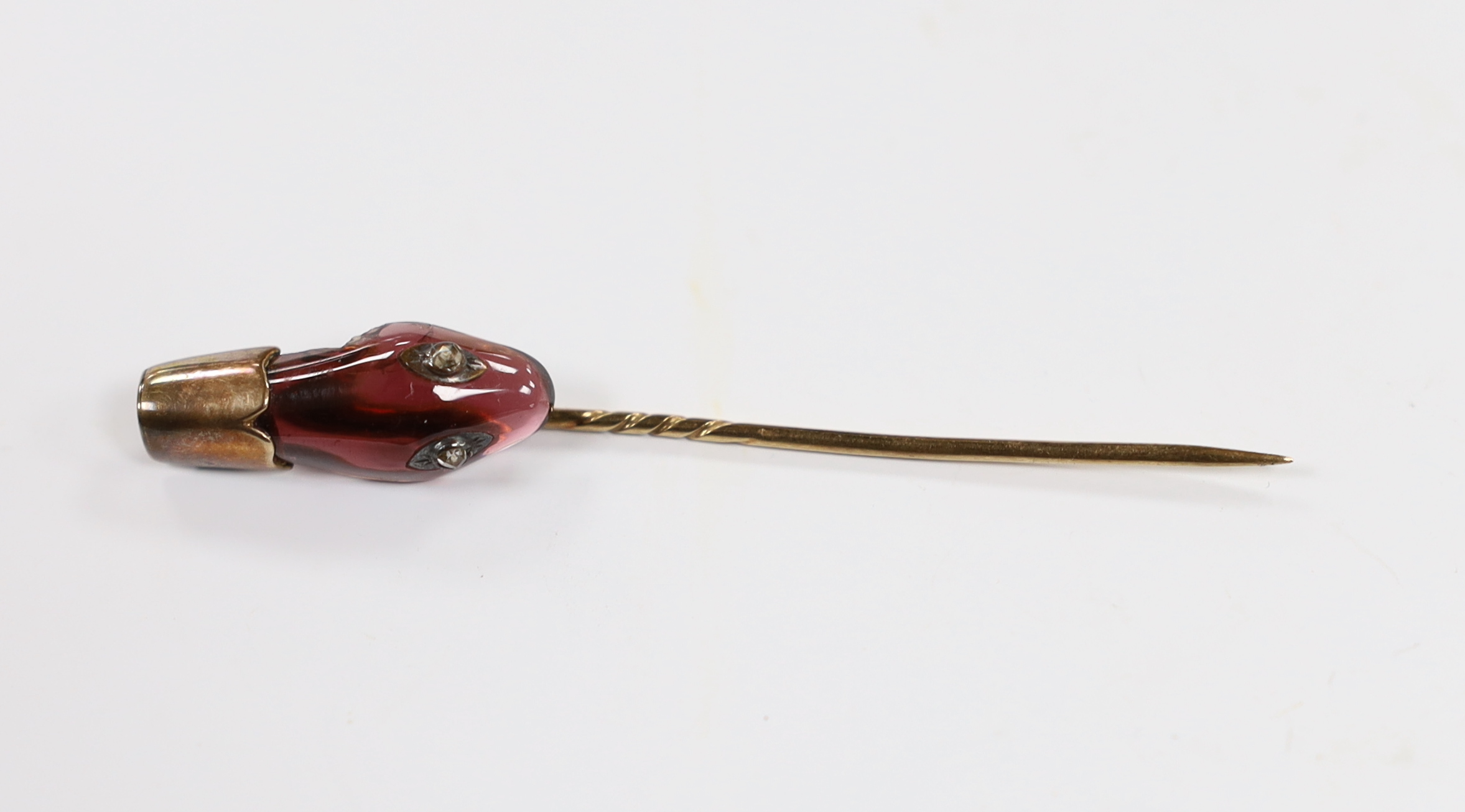 A late Victorian yellow metal, garnet and diamond set serpent head stick pin, 65mm, gross weight 2.9 grams (chip).